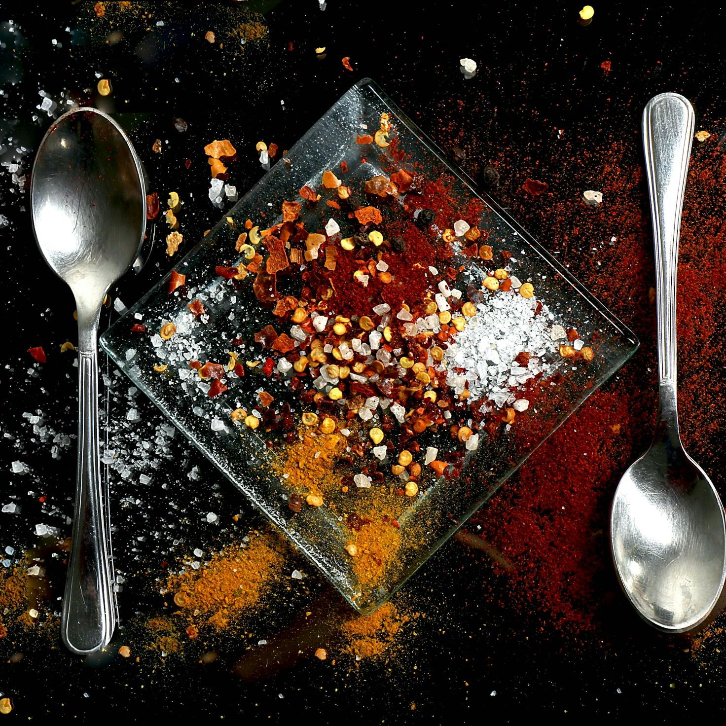 Diverse group of community members sharing a meal together, showcasing the social bonds formed through collaborative cooking